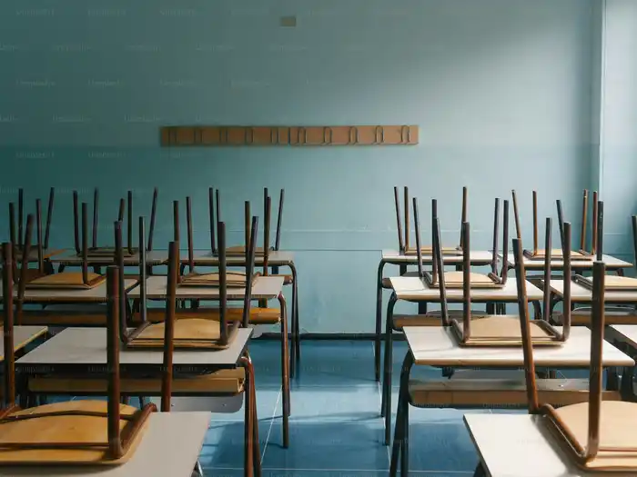 Chairs stacked on school desks